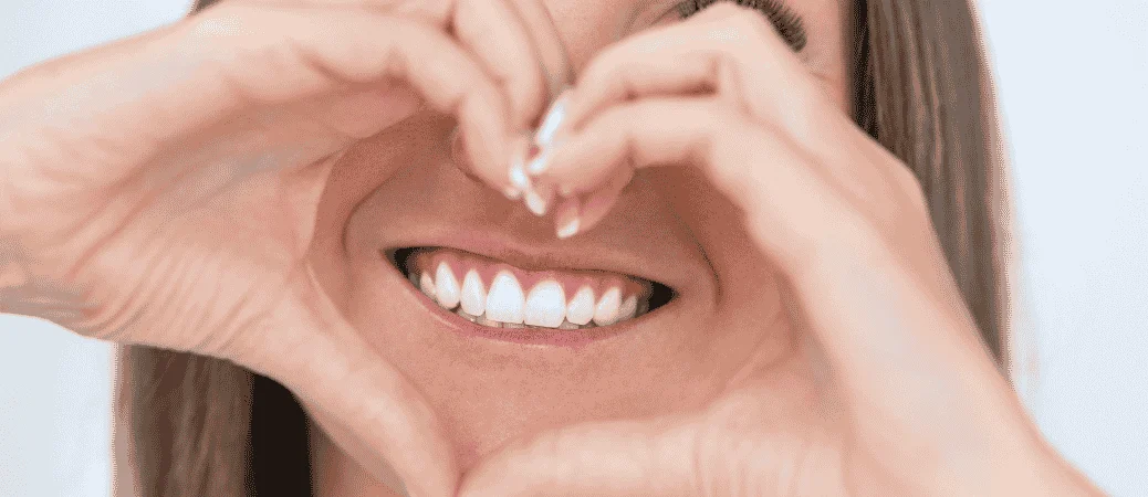 Hands forming a heart around a smile